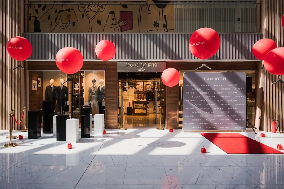 "Dan John" store entrance with red balloons and event decorations