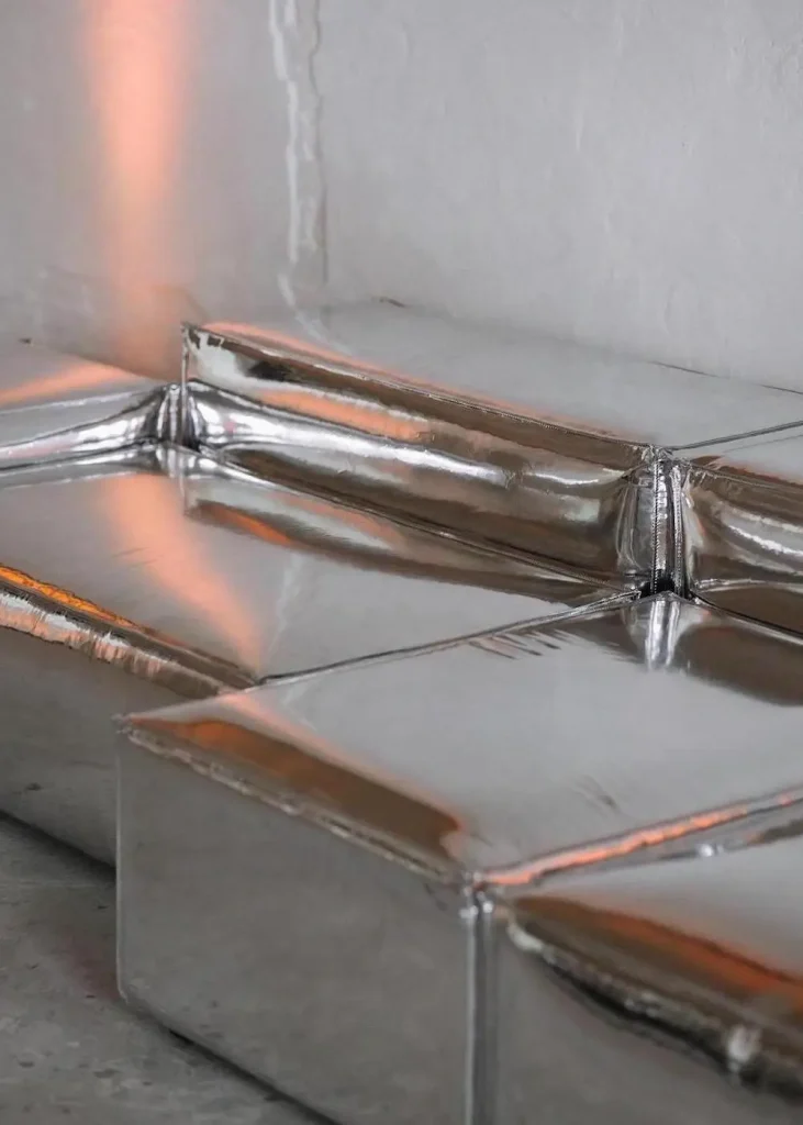 Shiny sofas with a reflective surface on a stone floor